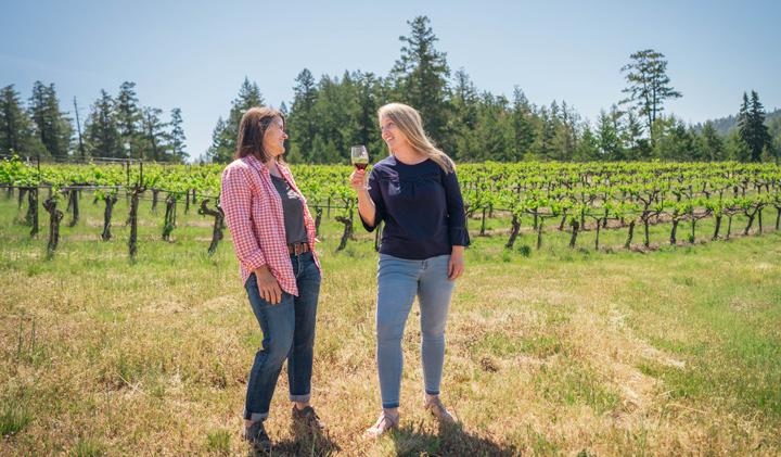 Amanda and Krista stand in the Knoll vineyard